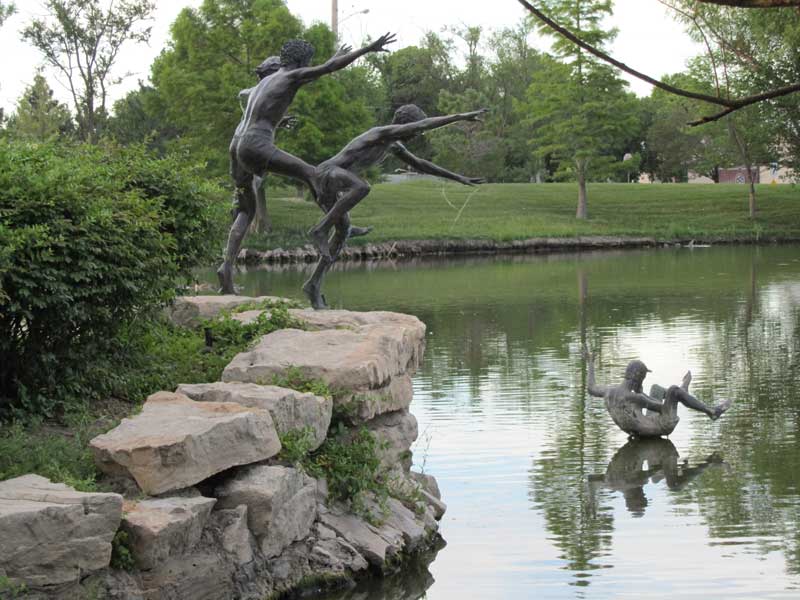 Statues by by a pond